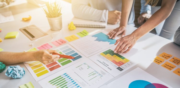 Business people meeting at office and use post it notes to share idea. Brainstorming concept. Sticky note on glass wall.