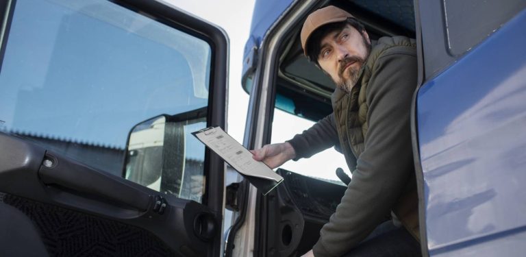 Kierowca ciężarówki wygląda z kabiny