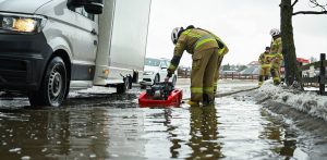Strażacy przepompowują wodę z roztopów na drodze lokalnej w Otominie k. Gdańska, 23.02.2026 r. (fot. PAP/Adam Warżawa)