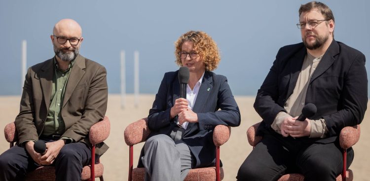 Trzy osoby siedzące w fotelach na plaży podczas konferencji prasowej festiwalu Dwa Teatry w Sopocie. W środku prezydent Sopotu Magdalena Czarzyńska-Jachim, po lewej Michał Kotański – dyrektor Teatru Telewizji, po prawej Adam Wojtyszko – dyrektor Teatru Polskiego Radia. W tle jasny piasek i błękitne niebo