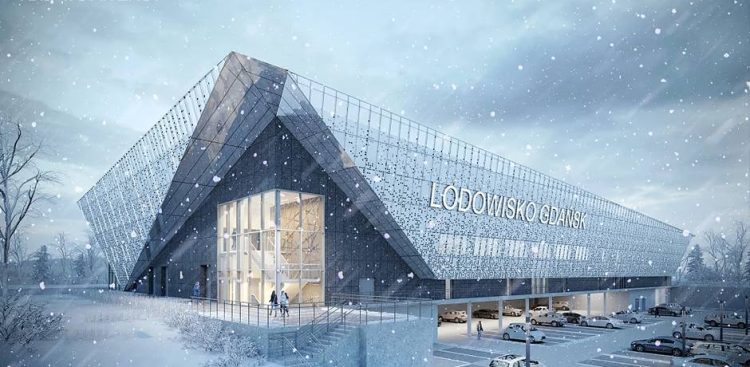 Wizualizacja miejskiego lodowiska w dzielnicy Ujeścisko-Łostowice w Gdańsku - nowoczesnego, bryłowego budynku z dużym napisem „LODOWISKO GDAŃSK” na elewacji, przedstawiona w zimowej scenerii z padającym śniegiem. U dołu widoczny jest parking z samochodami oraz oświetlone, przeszklone wejście