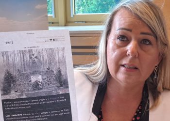 Sekretarz gminy Chojnice Lucyna Zawiszewska prezentuje zdjęcie pierwszego pomnika 18. Pułku Ułanów Pomorskich
