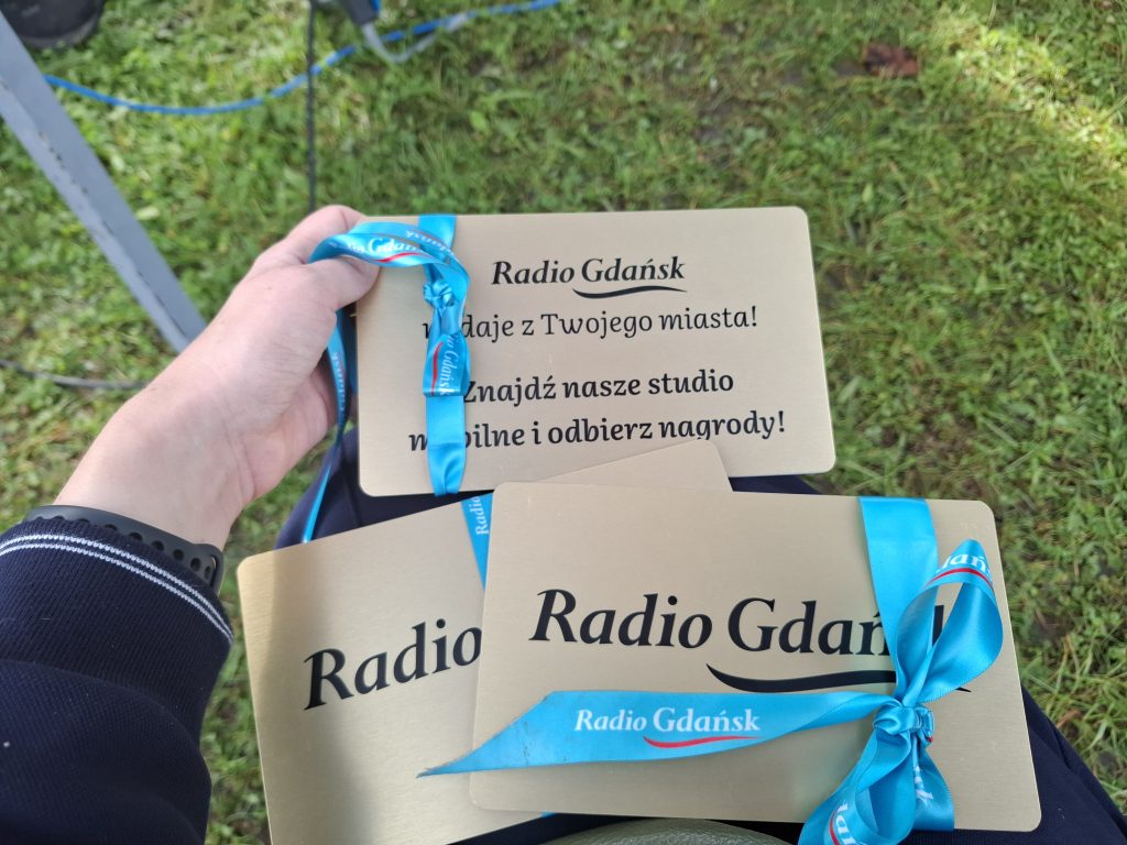 Złote tabliczki z niebieskimi kokardami - elemnt gry terenowej