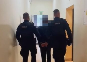 Dwaj umundurowani policjanci prowadzą korytarzem skutego kajdankami mężczyznę. To pijany maszynista, który przytrzasnął drzwiami kobietę z wózkiem na stacji kolejowej Racławki pod Chojnicami